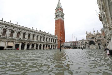 Wide view of Venice in Italy during the high tide in Winter with bell tower of Saint Mark in the main square